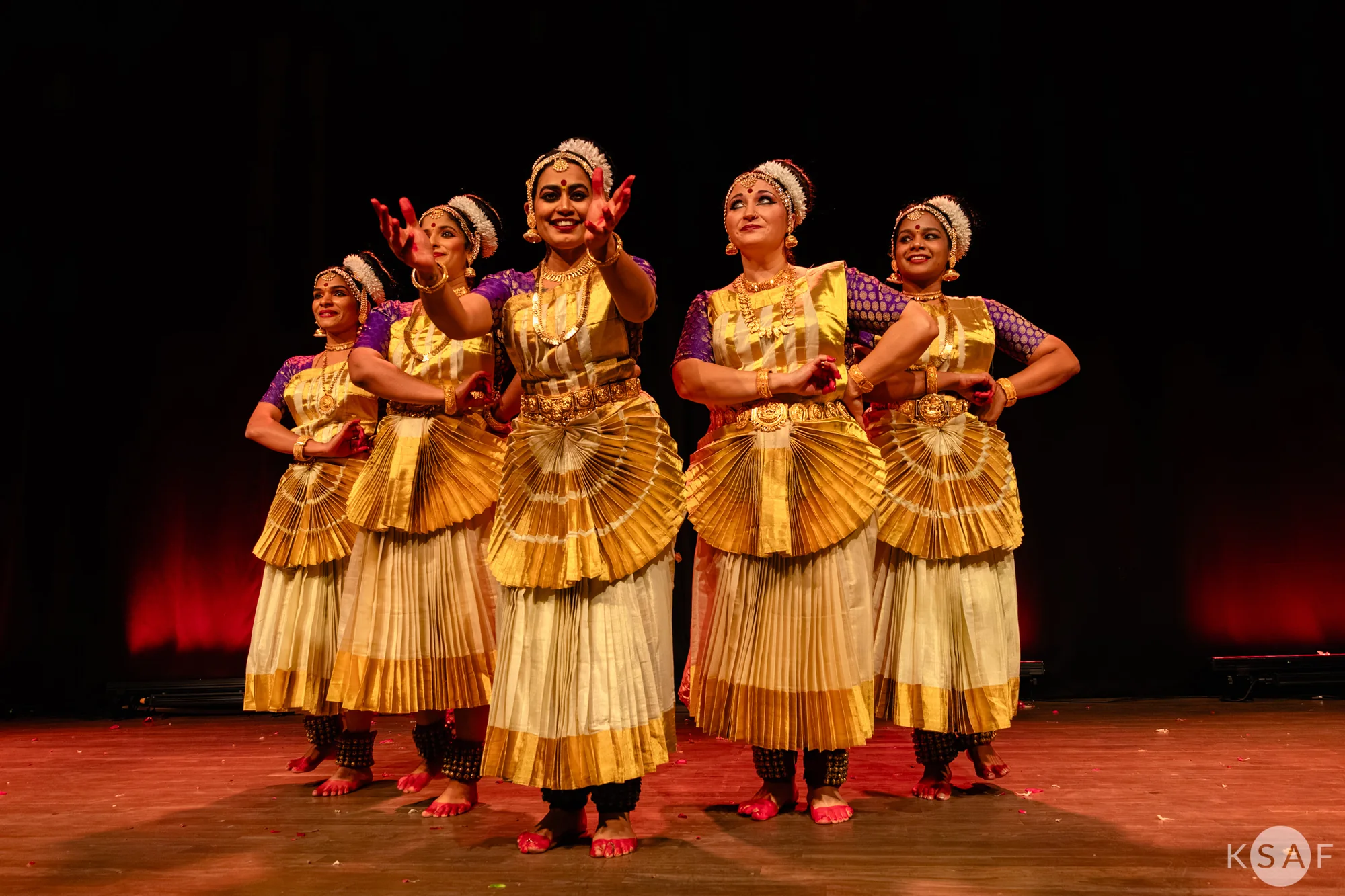 Four dancers performing together on stage