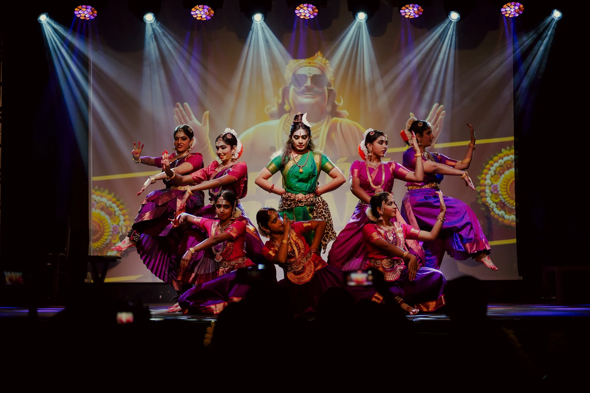 An ensemble performing under stage lights